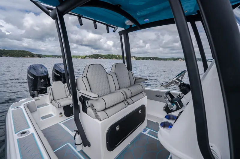 Slide: The Image of 2024 Glasstream 32 GSX boat interior with dual Mercury engines on a scenic lake. - 20