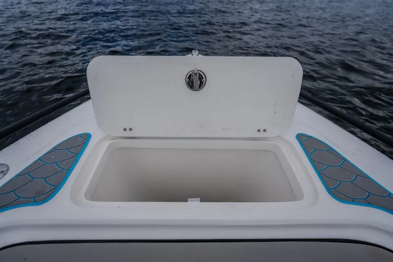 Slide: The Image of Open storage compartment on 2024 Glasstream 32 GSX boat, with water in the background. - 42