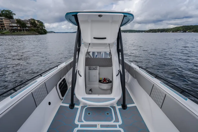 Slide: The Image of 2024 Glasstream 32 GSX boat interior with open cabin door on a scenic lake. - 46
