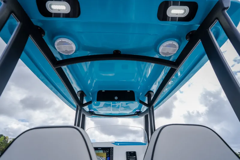 Slide: The Image of 2024 Glasstream 32 GSX boat interior with blue canopy and modern lighting. - 49