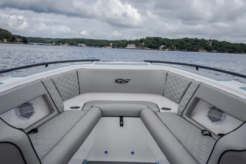 Slide: The Image of 2024 Glasstream 32 GSX boat interior with luxurious seating on a scenic lake. - 36