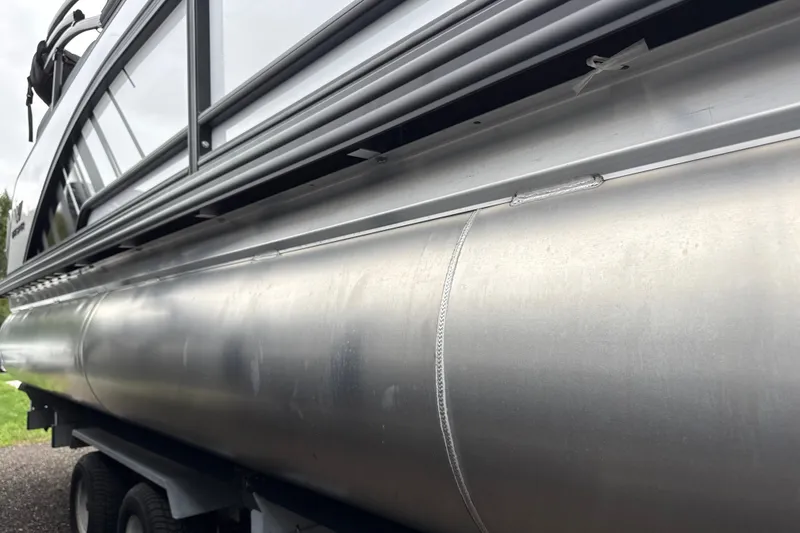 Slide: The Image of Close-up of 2027 Whisper VISION RLS 23V pontoon boat on trailer. - 12