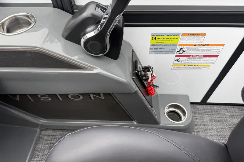 Slide: The Image of Control panel of Whisper VISION RLS 23V boat, featuring cup holders and safety warnings. - 26