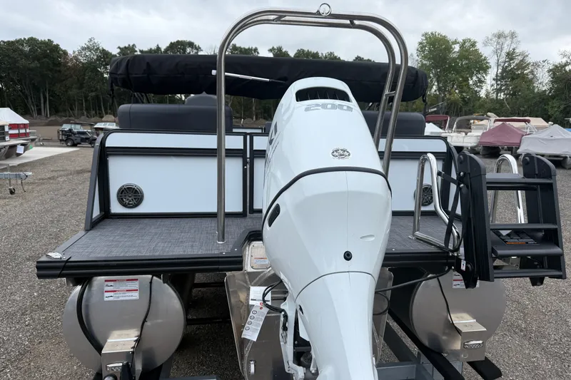 Slide: The Image of 2027 Whisper VISION RLS 23V boat with powerful outboard motor, docked outdoors. - 5