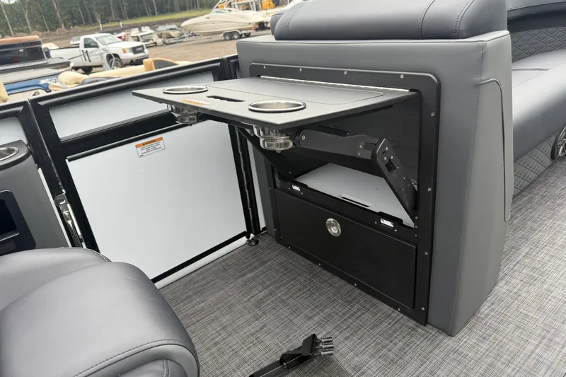 Slide: The Image of Interior of 2027 Whisper VISION RLS 23V boat with foldable table and cup holders. - 10