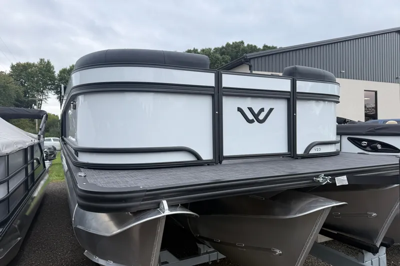 Slide: The Image of 2027 Whisper VISION RLS 23V pontoon boat displayed outdoors. - 13