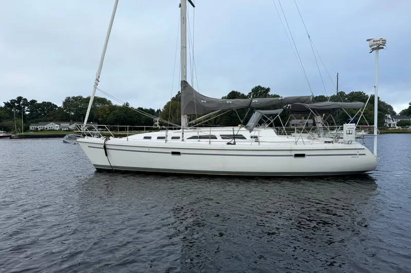 Slide: The Image of 1998 Catalina 380 sailboat on calm water, featuring sleek design and spacious deck. - 2