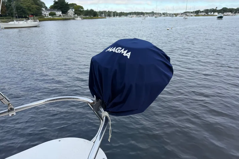 Slide: The Image of Covered grill on a 1998 Catalina 380 sailboat, overlooking a serene marina. - 10