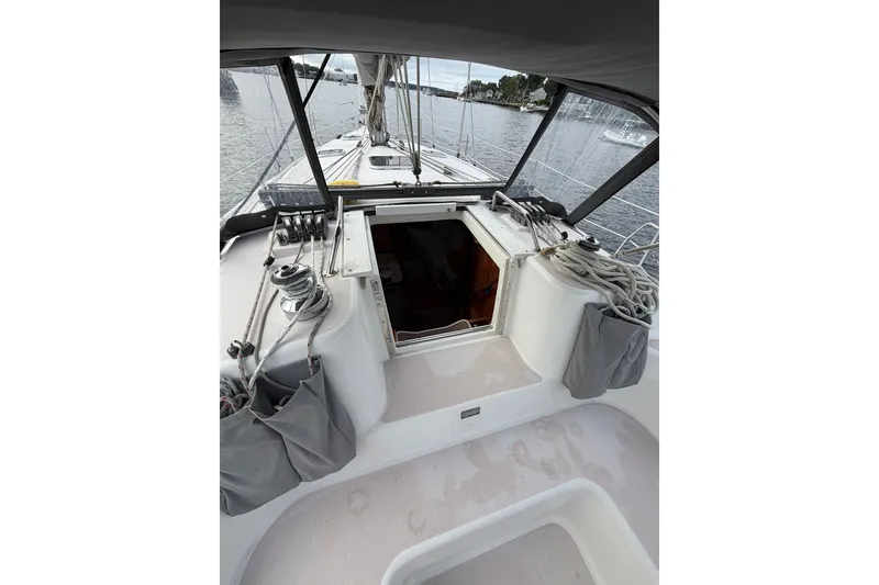 Slide: The Image of Cockpit view of a 1998 Catalina 380 sailboat with ropes and open hatch. - 19