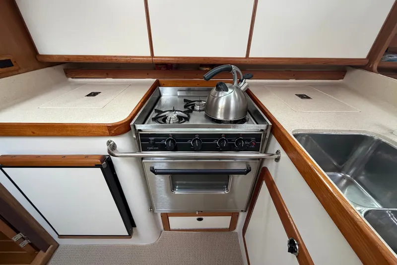 Slide: The Image of Galley kitchen in 1998 Catalina 380 yacht with stove, kettle, and sink. - 26