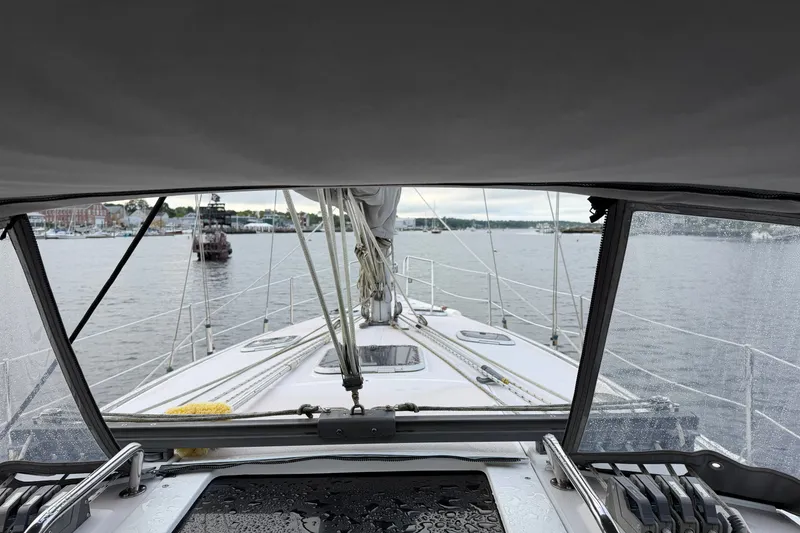 Slide: The Image of View from a 1998 Catalina 380 sailboat cockpit, overlooking a calm harbor. - 16