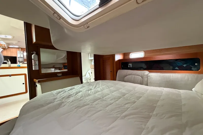Slide: The Image of Cozy cabin interior of a 1998 Catalina 380 sailboat with a comfortable bed and wooden accents. - 28