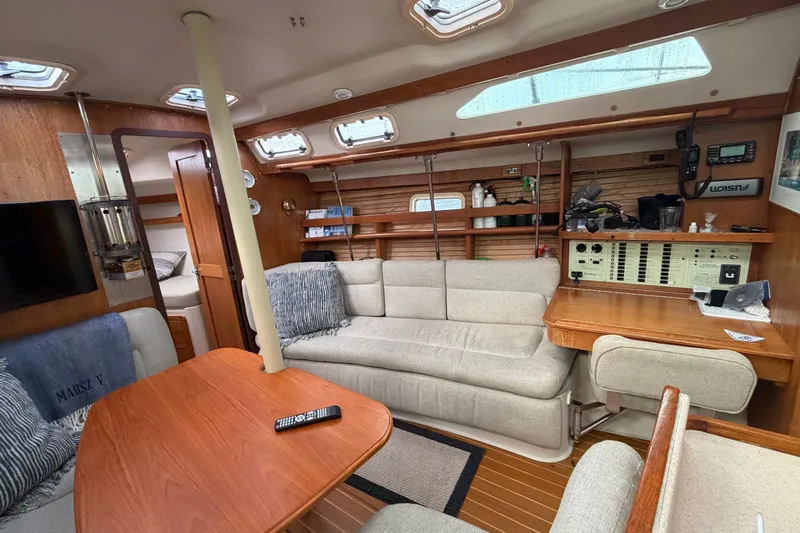 Slide: The Image of Interior of a 1998 Catalina 380 sailboat with cozy seating and navigation equipment. - 15