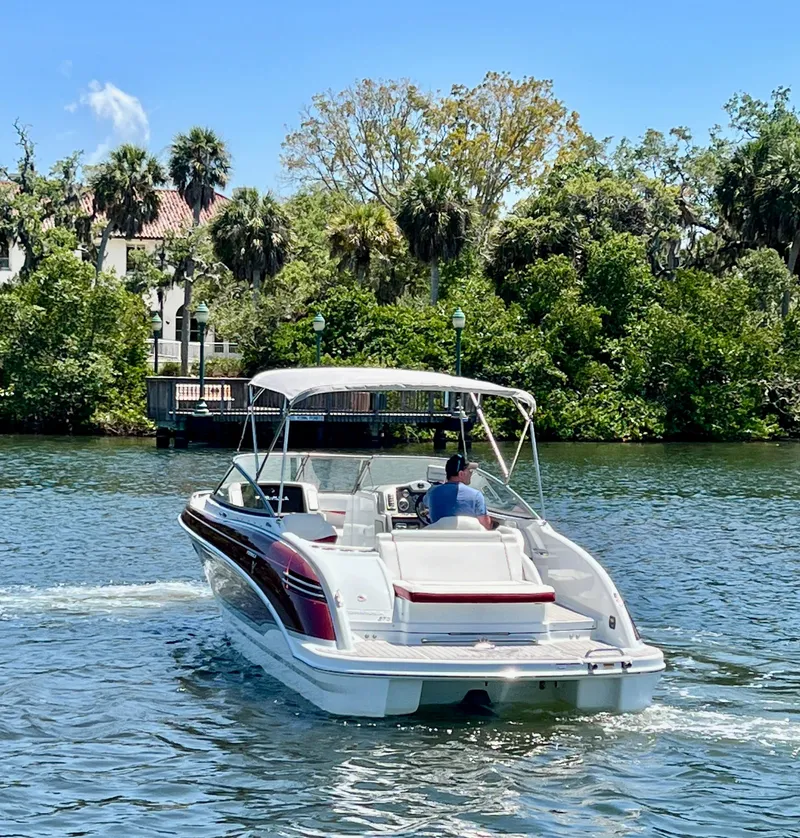 Slide: The Image of 2011 Formula 270 Bowrider cruising on a scenic waterway with lush greenery. - 10
