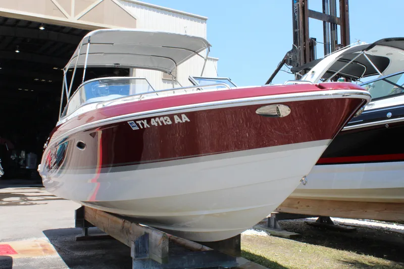 Slide: The Image of 2011 Formula 270 Bowrider boat in storage, red and white exterior. - 12