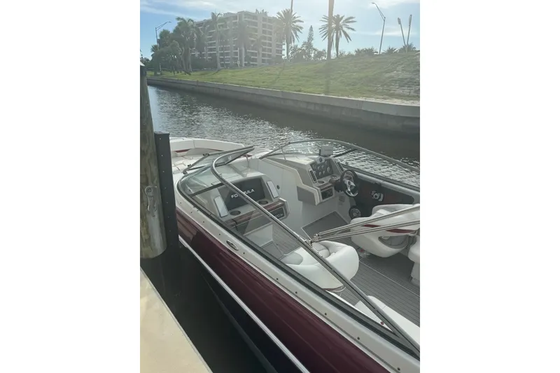 Slide: The Image of 2011 Formula 270 Bowrider docked by a canal, featuring sleek design and modern controls. - 27