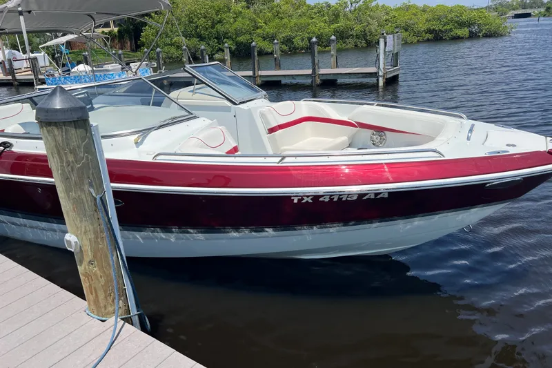 Slide: The Image of 2011 Formula 270 Bowrider boat docked, featuring red and white design. - 20