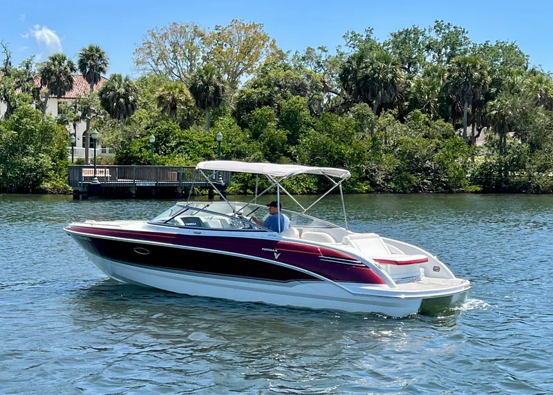 Slide: The Image of 2011 Formula 270 Bowrider boat cruising on a scenic waterway. - 1