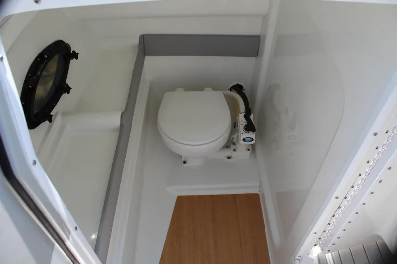 Slide: The Image of 2011 Formula 270 Bowrider boat interior bathroom with toilet and porthole. - 40