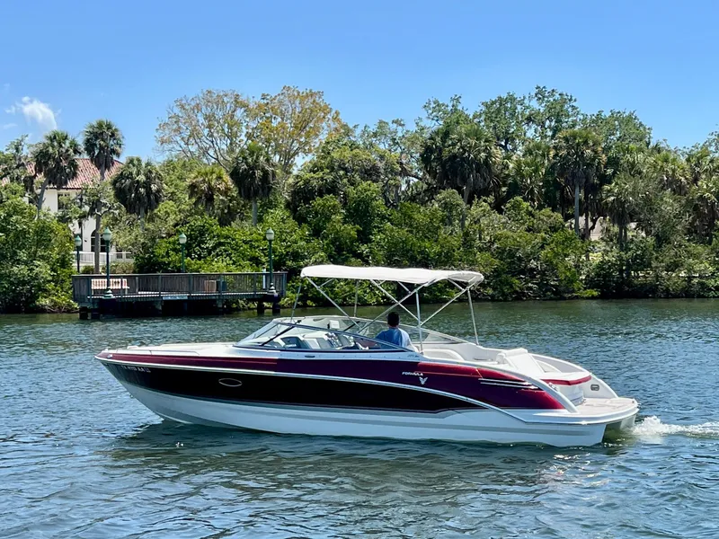 Slide: The Image of 2011 Formula 270 Bowrider cruising on a scenic river with lush greenery. - 8