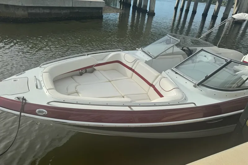 Slide: The Image of 2011 Formula 270 Bowrider boat docked, featuring sleek design and spacious seating. - 22