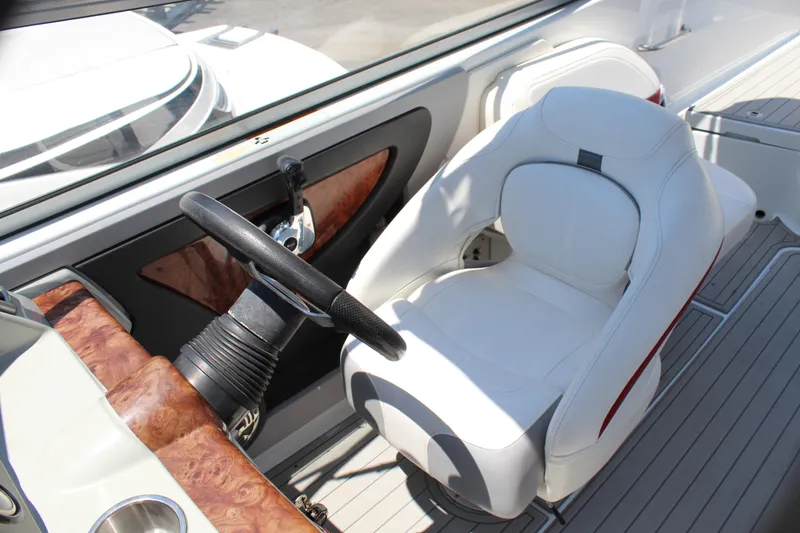 Slide: The Image of Captain's seat and steering wheel of a 2011 Formula 270 Bowrider boat. - 39