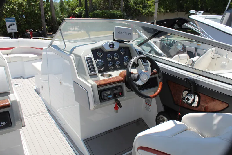 Slide: The Image of 2011 Formula 270 Bowrider boat interior with steering wheel and dashboard. - 33
