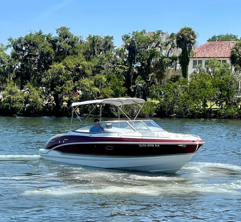 Slide: The Image of 2011 Formula 270 Bowrider cruising on a scenic waterway with lush greenery. - 6