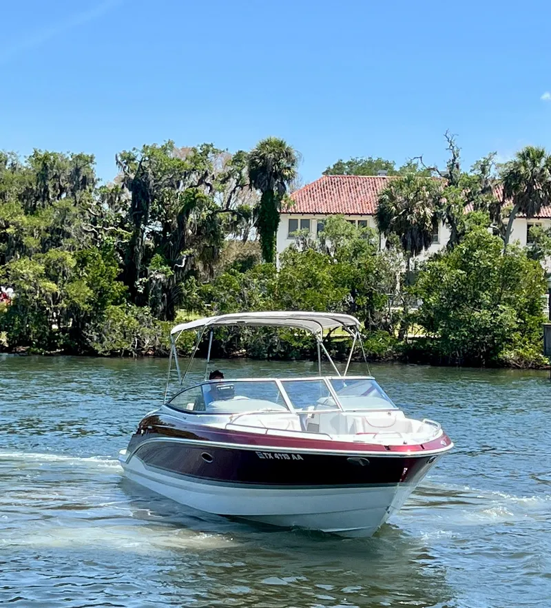 Slide: The Image of 2011 Formula 270 Bowrider cruising on a scenic river with lush greenery. - 7