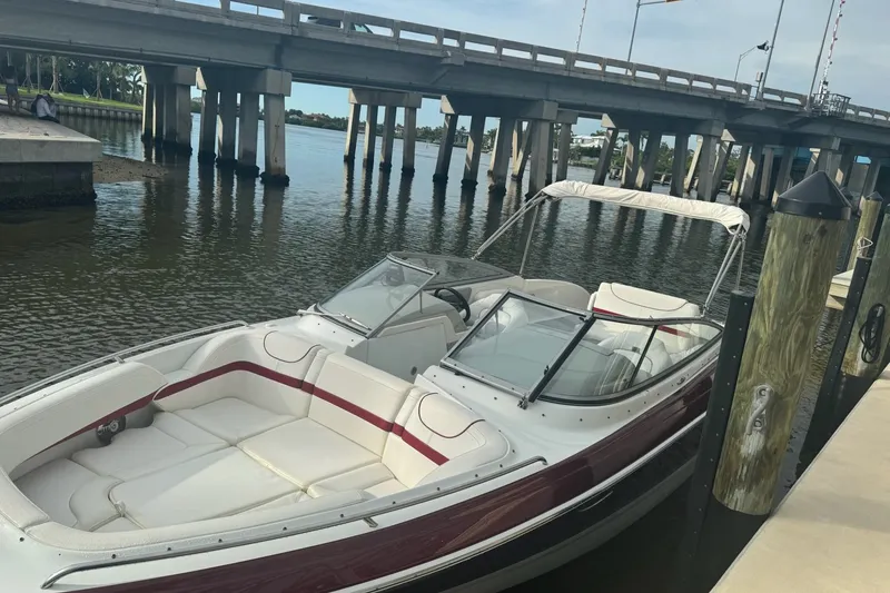 Slide: The Image of 2011 Formula 270 Bowrider docked near a bridge on a calm waterway. - 23
