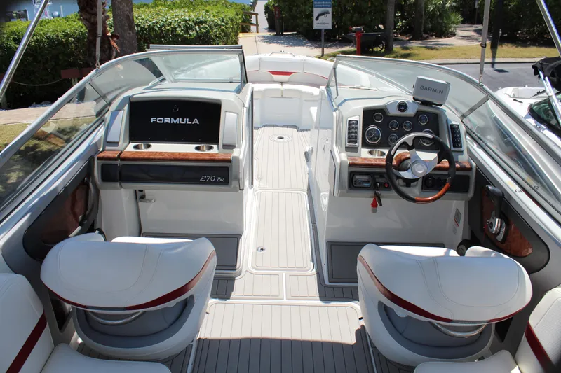 Slide: The Image of 2011 Formula 270 Bowrider boat interior with steering wheel and seating. - 31