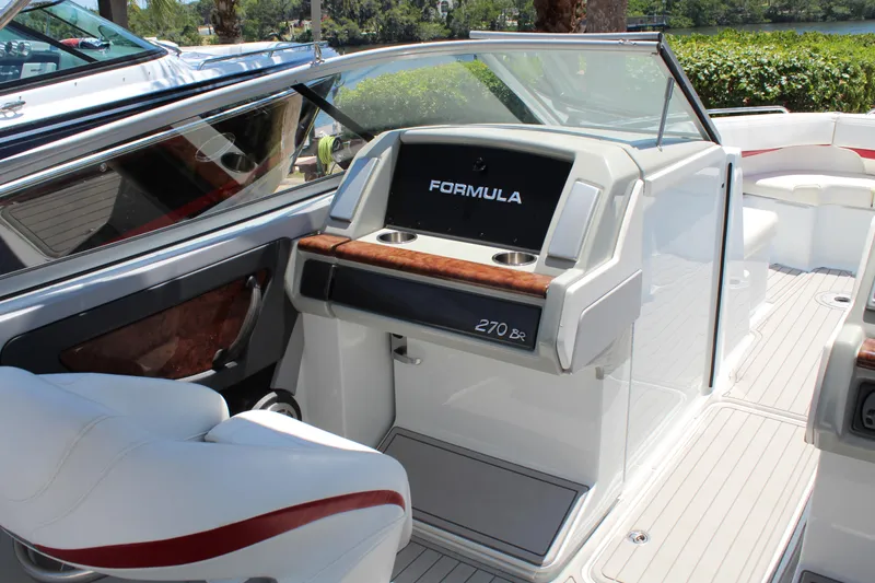 Slide: The Image of 2011 Formula 270 Bowrider boat interior with seating and dashboard. - 32