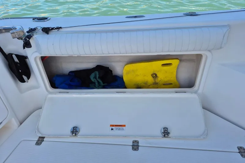 Slide: The Image of Storage compartment on a 2004 Riviera 4000 Offshore boat with gear and a yellow float. - 10