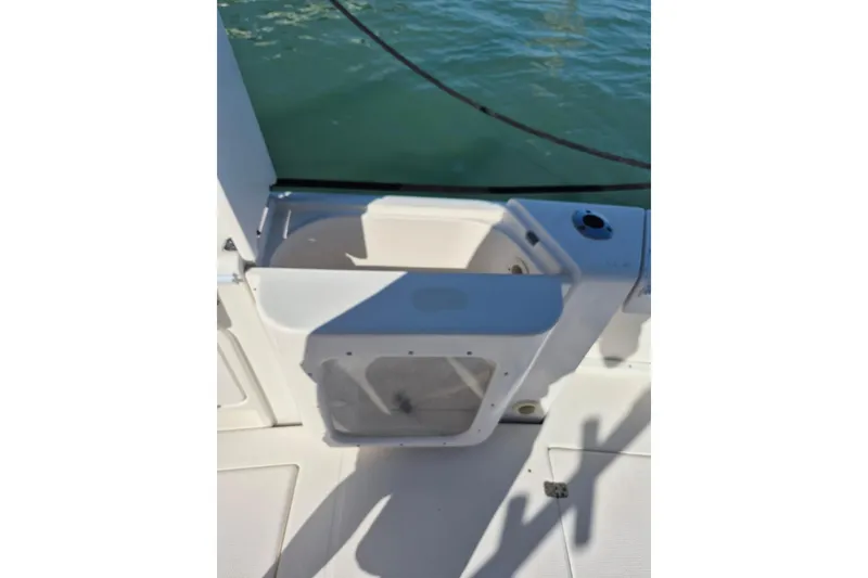 Slide: The Image of 2004 Riviera 4000 Offshore boat deck with storage compartment and water view. - 77