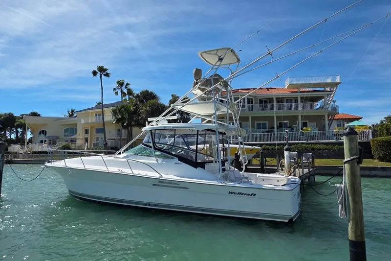 Slide: The Image of ```json { "alt_text": "2004 Riviera 4000 Offshore boat docked near waterfront homes." } ``` - 1