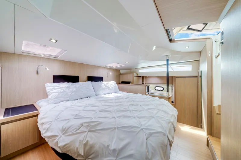 Slide: The Image of Luxurious bedroom interior of 2019 Aquila 44 Yacht with elegant bedding and natural light. - 53