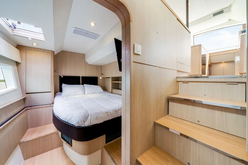 Slide: The Image of Luxurious interior of 2019 Aquila 44 Yacht featuring a cozy bedroom and wooden staircase. - 58