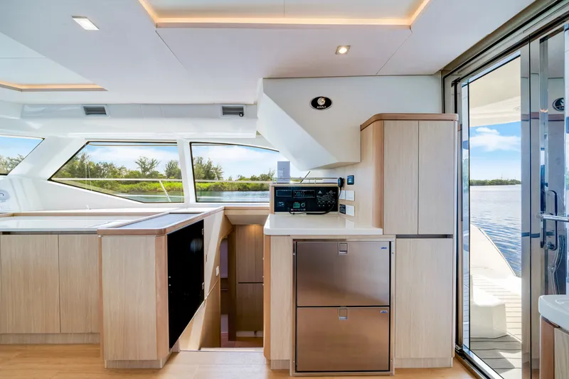 Slide: The Image of Interior of 2019 Aquila 44 Yacht with modern kitchen and scenic water view. - 38