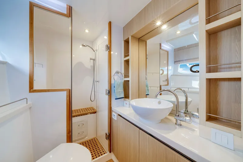 Slide: The Image of Luxurious bathroom interior of 2019 Aquila 44 Yacht with modern fixtures and wooden accents. - 57