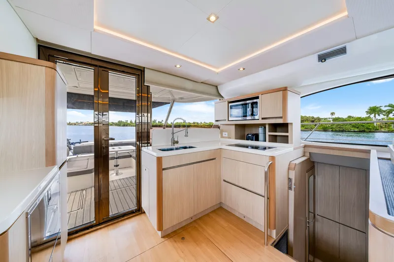 Slide: The Image of Luxurious interior of 2019 Aquila 44 Yacht with modern kitchen and scenic water view. - 44
