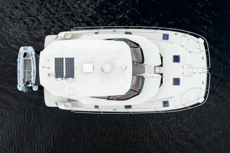 Slide: The Image of Aerial view of 2019 Aquila 44 Yacht with solar panels and attached dinghy. - 14