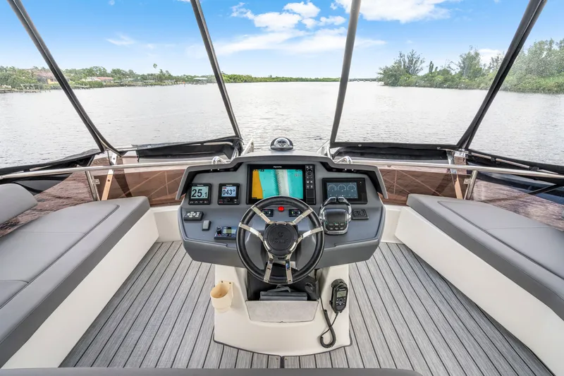 Slide: The Image of Cockpit view of 2019 Aquila 44 Yacht with modern navigation equipment and scenic waterway. - 29