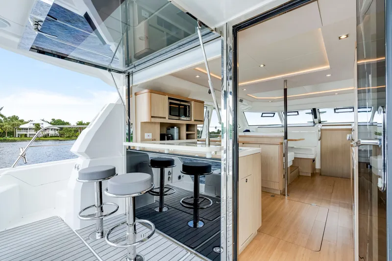 Slide: The Image of Luxurious interior of 2019 Aquila 44 Yacht with modern kitchen and seating area. - 24