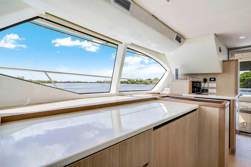 Slide: The Image of Interior of 2019 Aquila 44 Yacht with modern kitchen and scenic water view. - 45