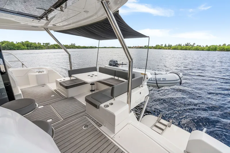 Slide: The Image of Luxurious 2019 Aquila 44 Yacht deck with seating, overlooking serene waters. - 21