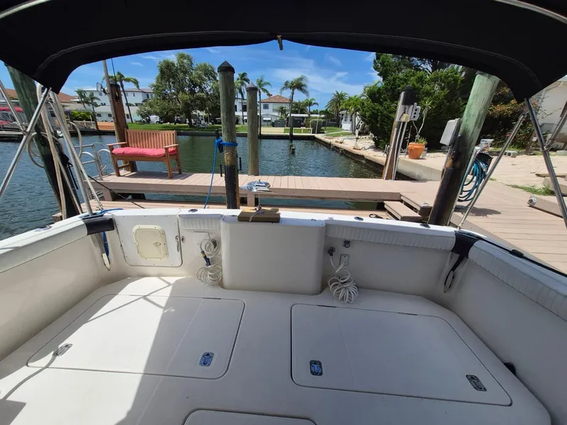 Slide: The Image of 2002 Silverton 38 Convertible boat interior at dock, sunny day, waterfront view. - 23