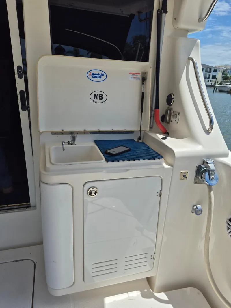 Slide: The Image of Outdoor sink and storage on a 2002 Silverton 38 Convertible yacht. - 21