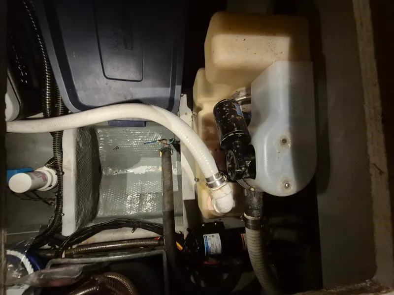 Slide: The Image of Engine compartment of a 2002 Silverton 38 Convertible boat, showing hoses and components. - 36