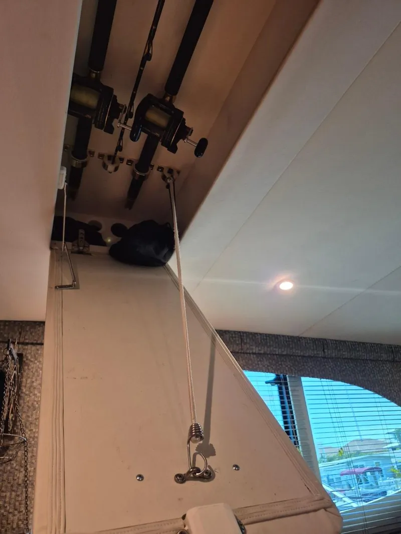 Slide: The Image of Interior view of 2002 Silverton 38 Convertible with fishing rods stored overhead. - 47