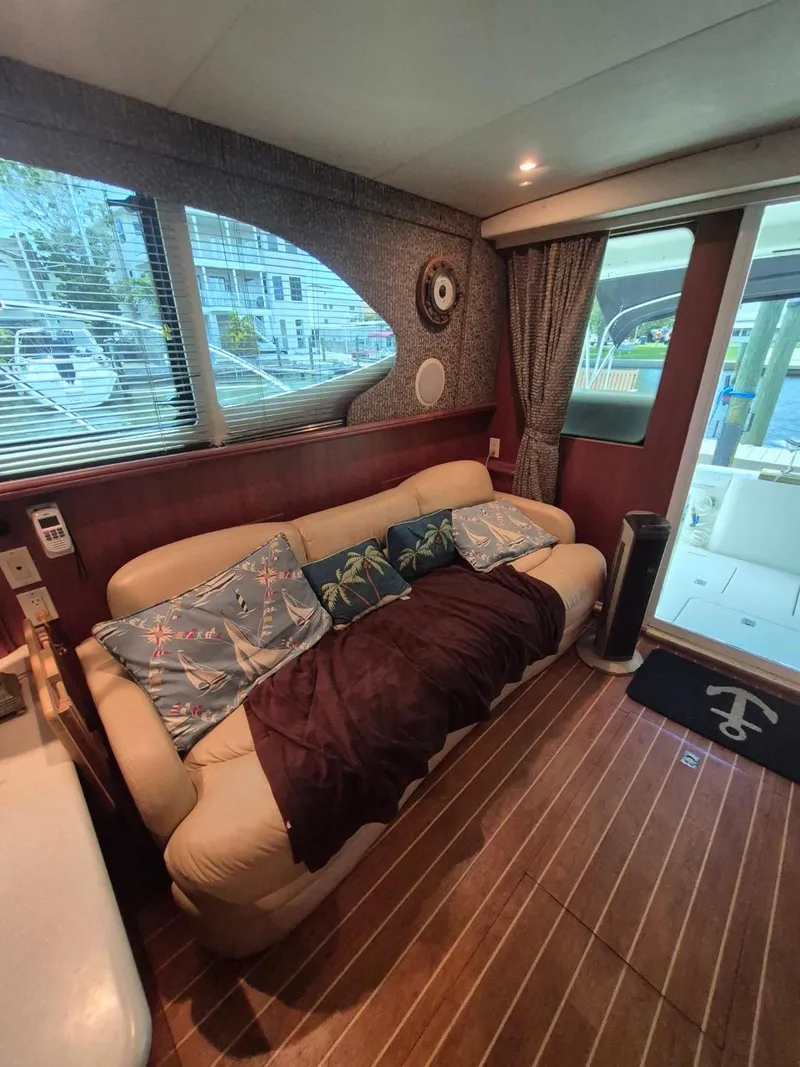 Slide: The Image of Interior of 2002 Silverton 38 Convertible yacht with cozy seating and nautical decor. - 48